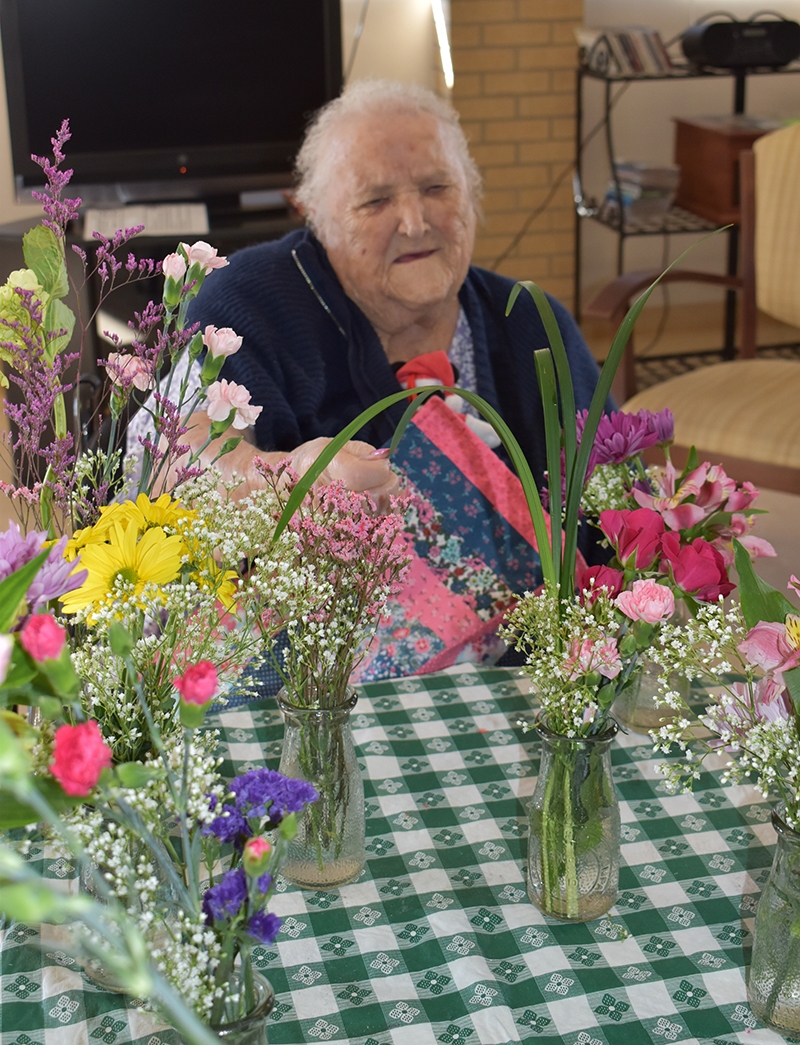 Marjorie-with-flowers-and-vases-03-30-22